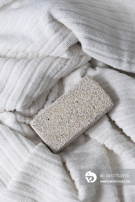 Pumice stone on white spa towel