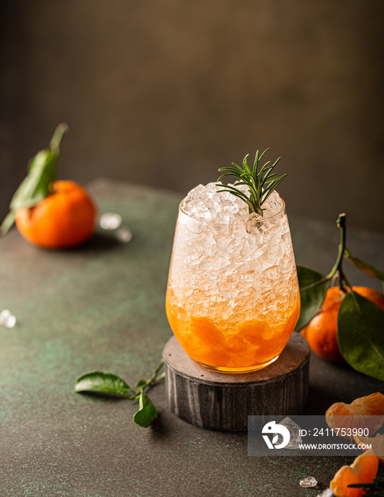 Fresh cocktail with crushed ice, rosemary and tangerines