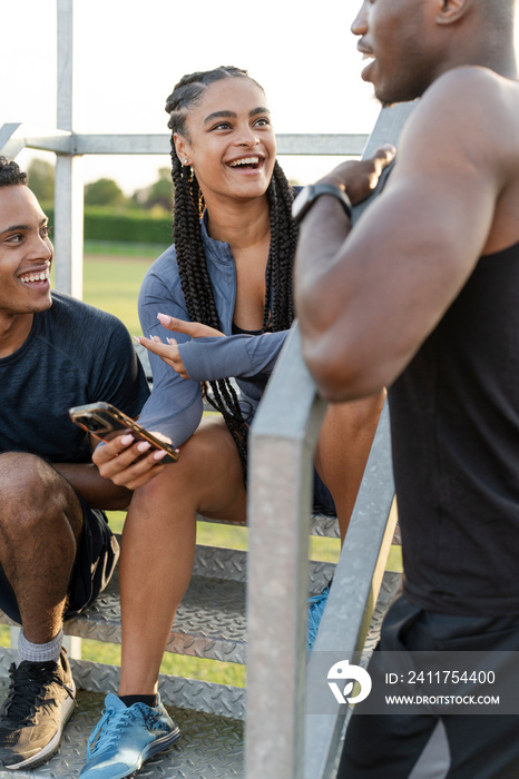 Group of athletes sitting on steps at stadium