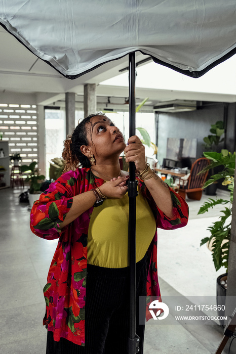 Plus sized female getting her headshots taken by a south asian female photographer