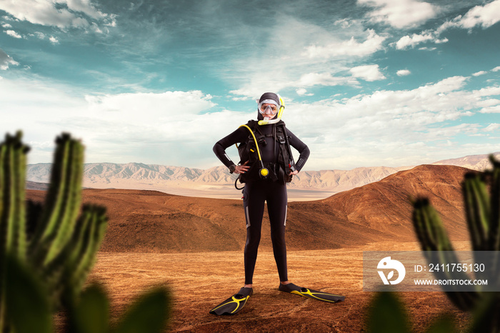 Diver standing in desert, underwater sport