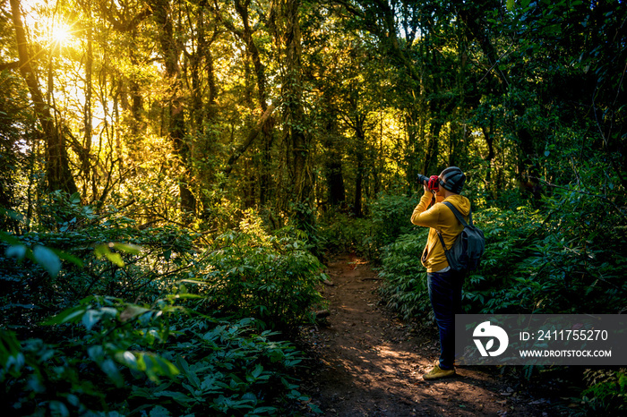 Professional photographer takes photos with camera in the forest