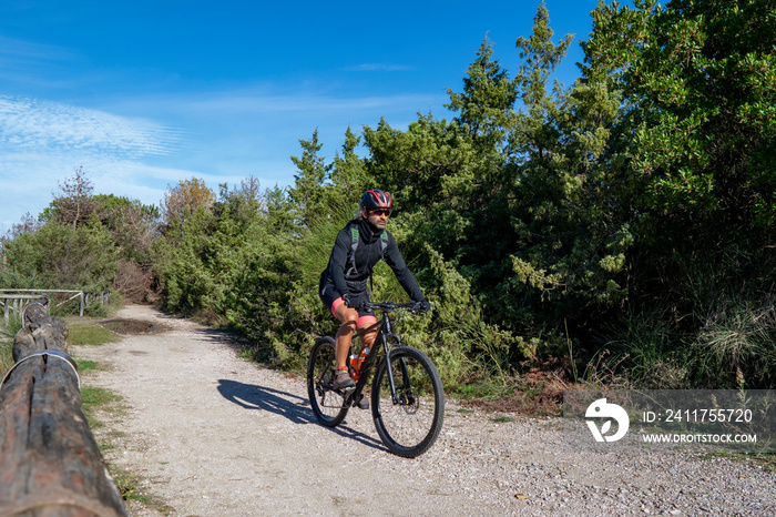 A biker on the traks of San Rossore and Massaciuccoli Natural Park, Tuscany