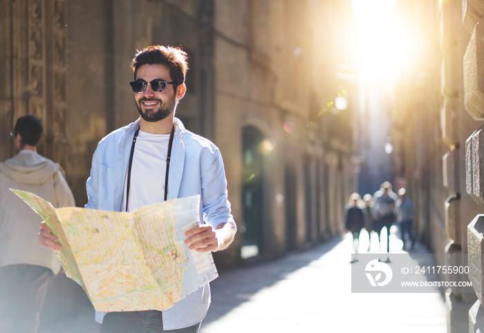 Happy man with map on street