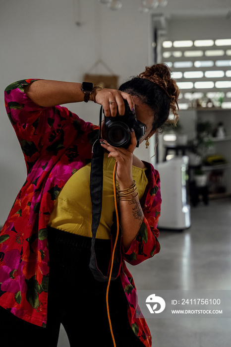 Plus sized female getting her headshots taken by a south asian female photographer