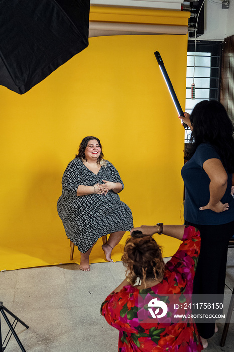 Plus sized female getting her headshots taken by a south asian female photographer