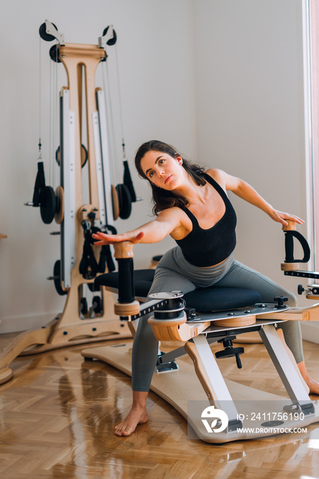 Fit girl trains in working machine at studio