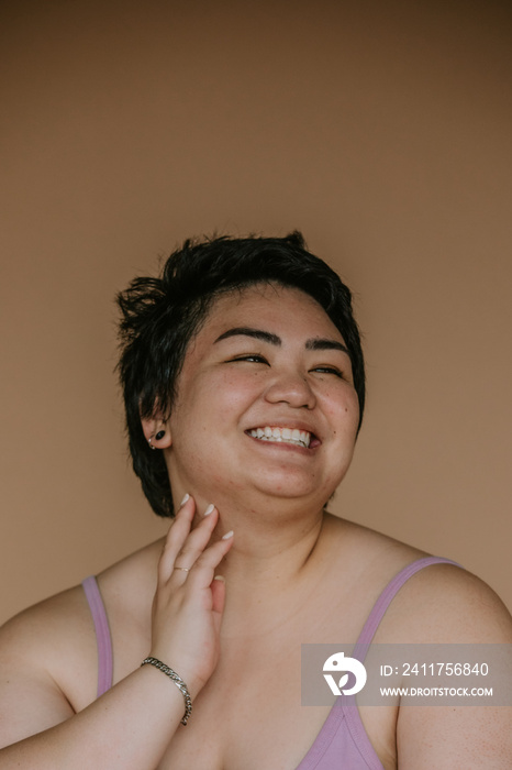 portrait of a plus size filipino woman with short hair smiling