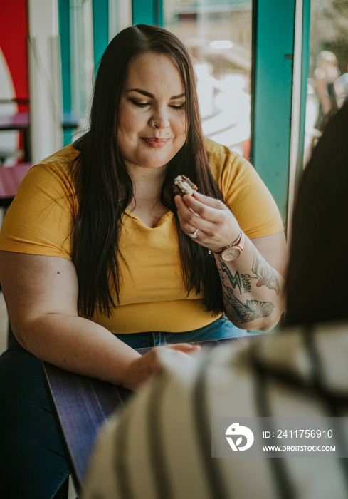 plus size Metis women eats snack