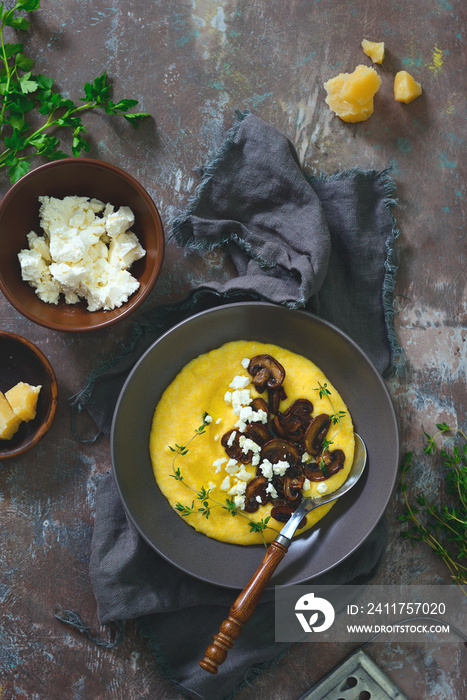 Cheesy corn porridge with mushrooms, overhead view