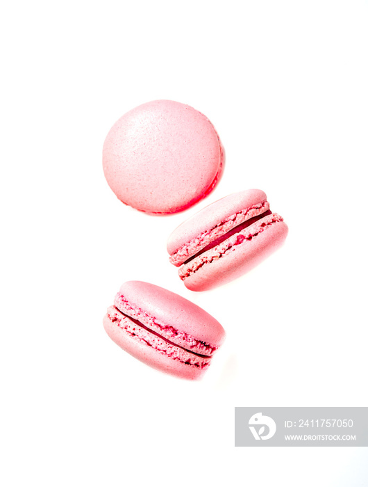 Three pink macaroon cookies isolated on white background