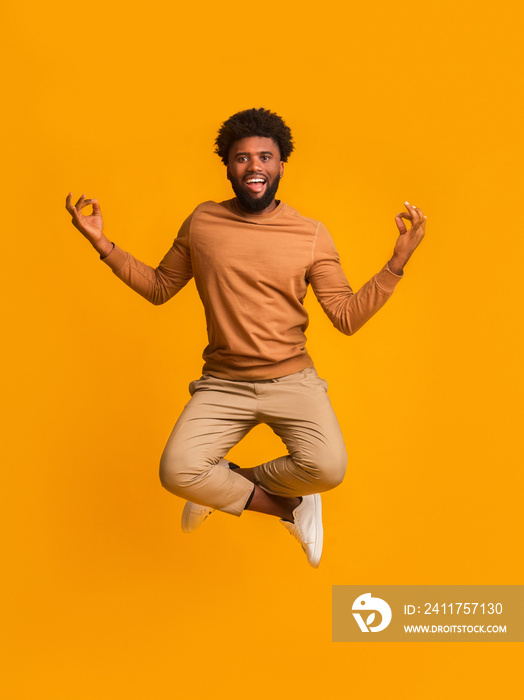 Peaceful black yogi guy meditating in the air