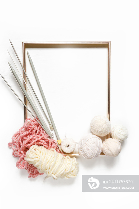 Knitting flat lay composition frame made of yarn knitting needles on a white background, creative work hobby handmade knitting