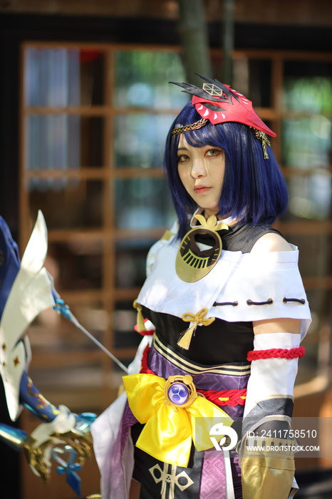 Japanese young woman hunter cosplay with bow on Japanese garden