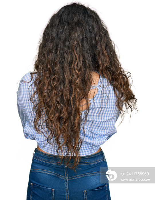 Young hispanic girl wearing casual clothes standing backwards looking away with crossed arms