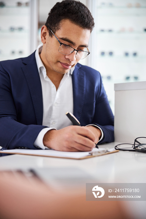 Concentrated male buyer filling out the form