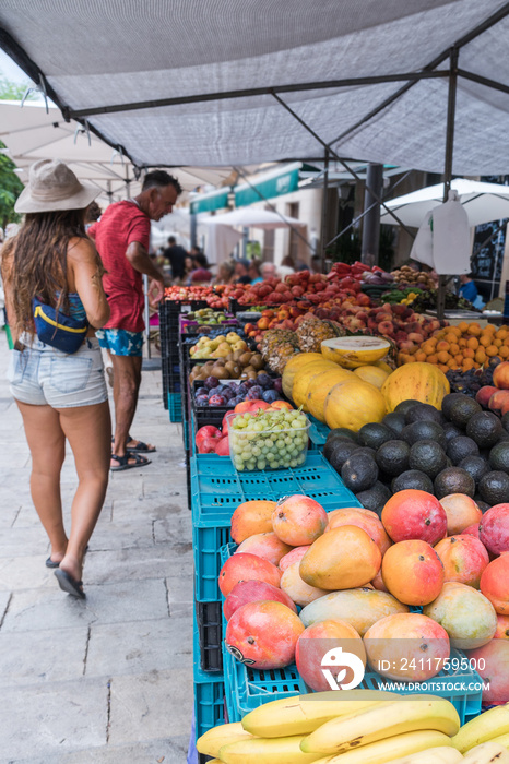 Two people looking for fruits in a street fair in majorca, Spain