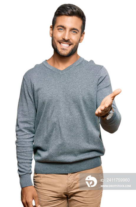 Handsome hispanic man wearing casual clothes smiling friendly offering handshake as greeting and welcoming. successful business.