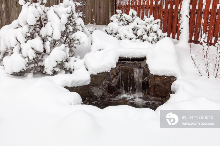 Snow covered outdoor water feature  after US northwest winter storm.