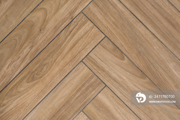 Oak wood texture of floor with tiles immitating hardwood flooring. Traditional herringbone pattern