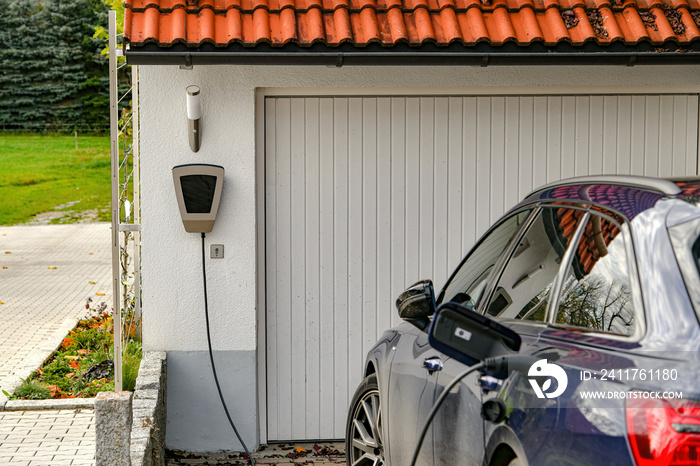 An electric car is charged from a gas station in a private house.