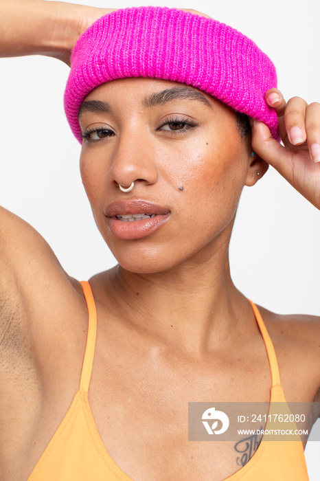 Studio portrait of woman in pink woolen cap