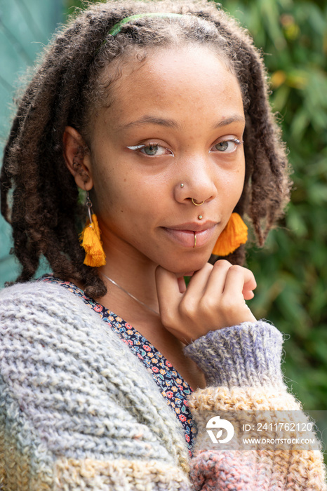 Portrait of young woman standing in garden