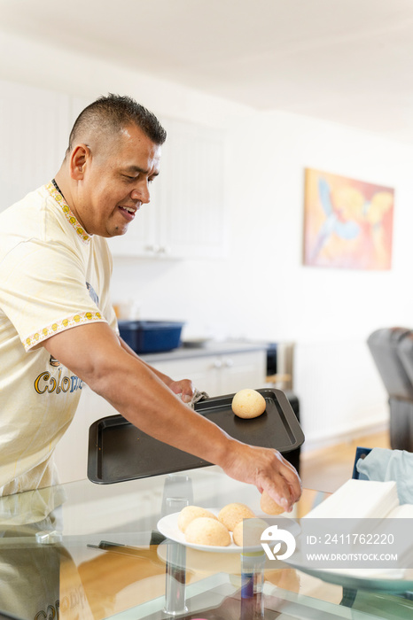 Man holding tray of freshly baked buns