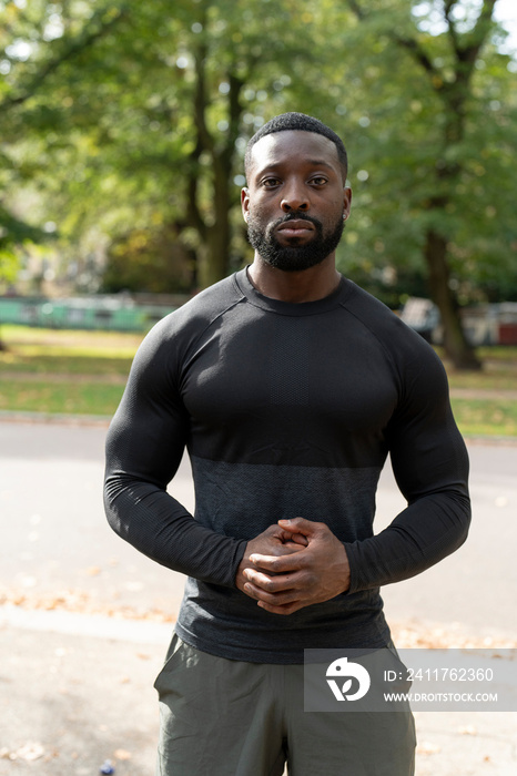 Portrait of athletic man standing in park