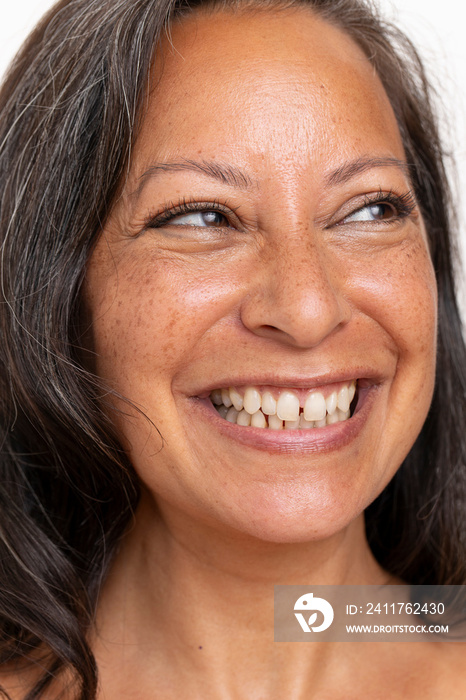 Close-up of smiling woman looking on side