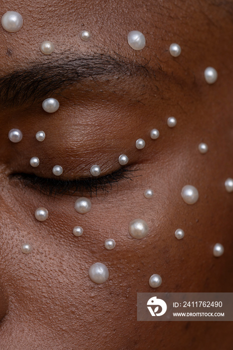 Close-up of woman wearing pearl freckles