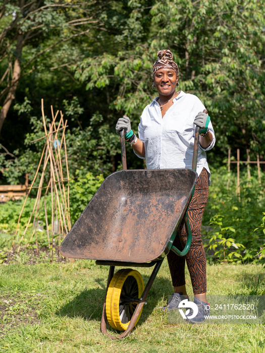 Portrait of smiling mature woman gardening in allotment