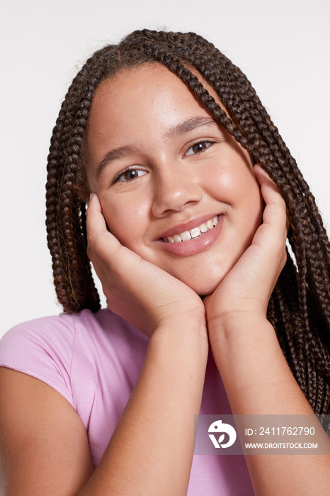 Studio portrait of smiling girl with braided hair