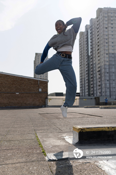 Portrait of young woman jumping in air