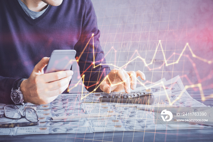 Double exposure of man’s hands holding and using a digital device and forex graph drawing. Financial market concept.