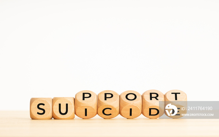 Suicide support concept. Flipping wooden blocks with words on table. Copy space