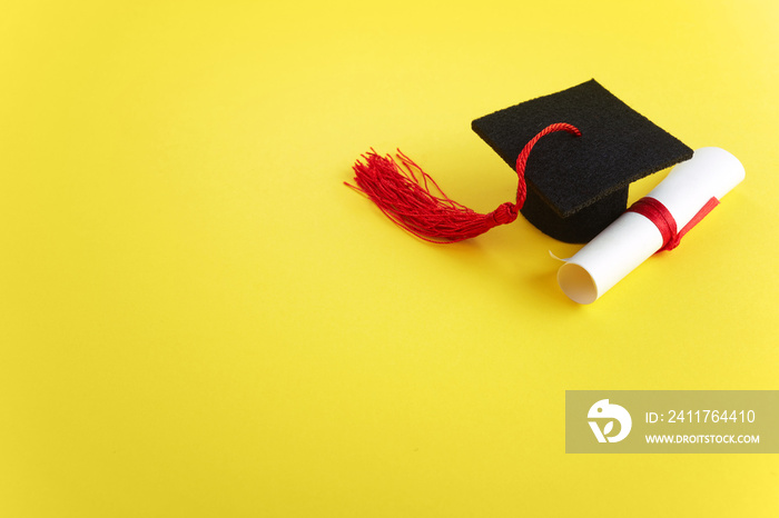 Academic hat with diploma on yellow background. Graduation theme