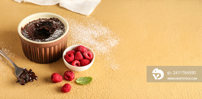 Ramekin with tasty lava cake and raspberries on color background with space for text