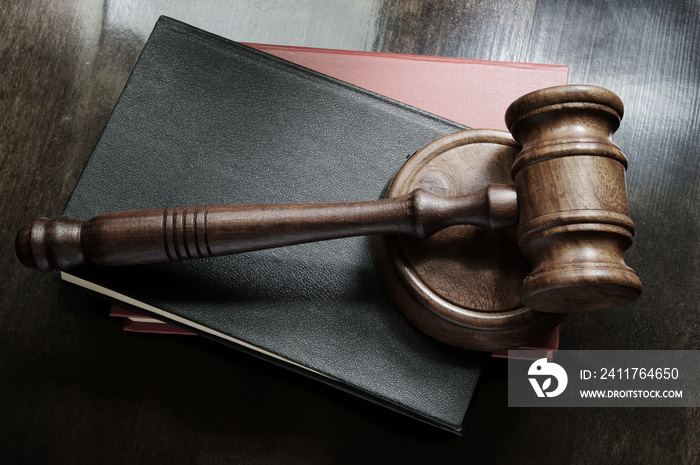 Judge gavel and legal books on wooden table, law concept