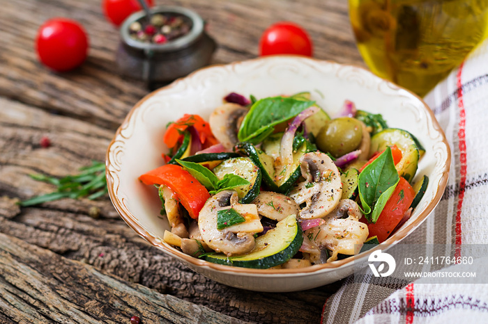 Saute with mushrooms, zucchini, tomatoes, onions and olives. Vegetable stew. Vegetarian, vegan food. Healthy meal.