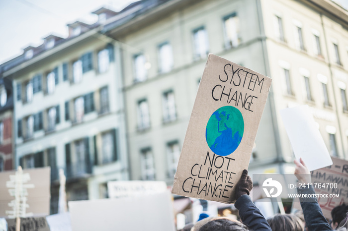 Group of demonstrators fight for climate change - Global warming and enviroment concept - Focus on banner