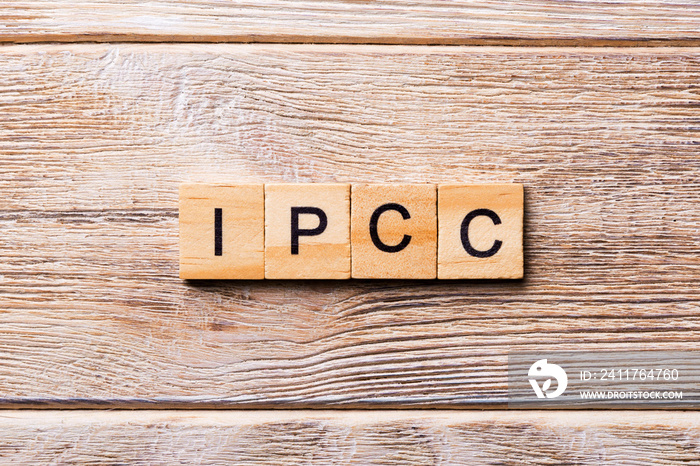 IPCC word written on wood block. abbreviation Intergovernmental Panel on Climate Change text on wooden table for your desing, concept