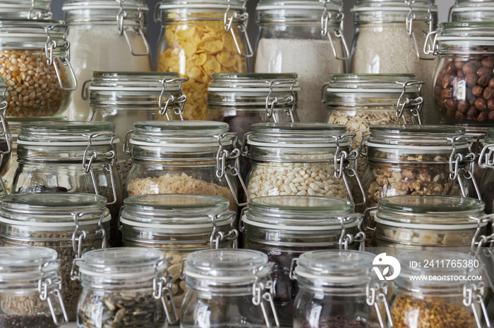 Close up of variety of dry foods, grains, nuts, cereals in glass jars. Zero waste storage concept.