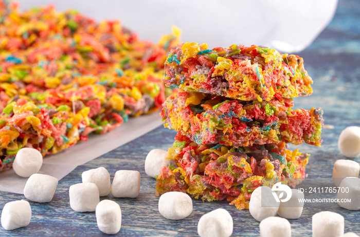 Fruity Cereal Marshmallow Treat Bars on a Wooden Table