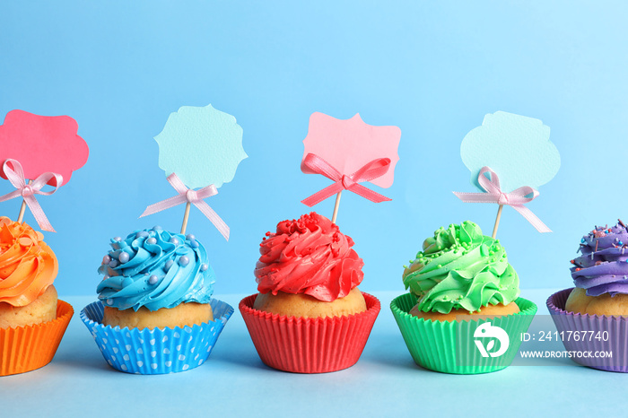 Tasty cupcakes on color background