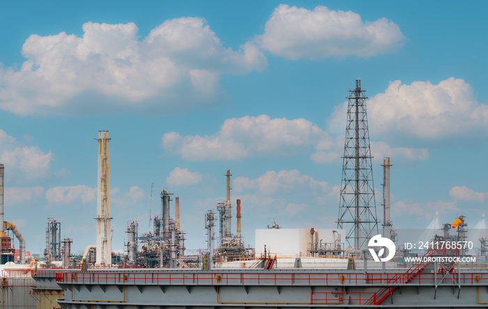 Oil refinery or petroleum refinery plant with blue sky background. Power and energy industry. Oil and gas production plant. Petrochemical industry. Natural gas storage tank. Petroleum business.