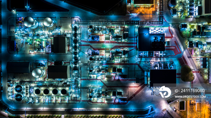 Oil refinery plant form industry zone, Aerial view oil and gas industrial, Refinery factory oil storage tank and pipeline steel at night.