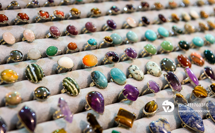 Display with different design of handmade rings with stones gems