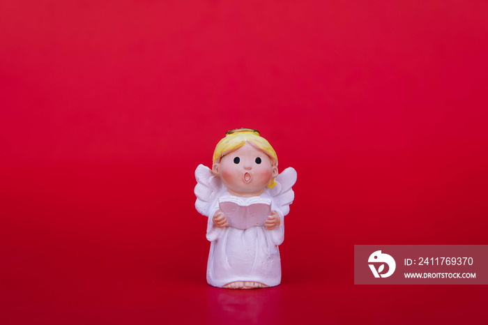 Cupid doll and heart-shaped on red background