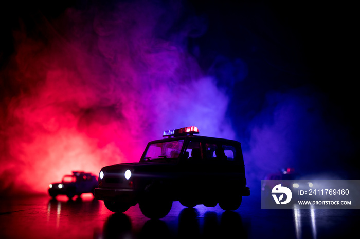 Police car chasing a car at night with fog background. 911 Emergency response police car speeding to scene of crime. Selective focus